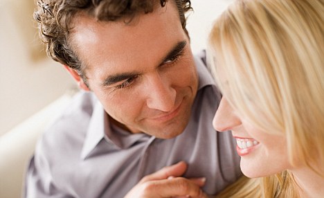 Young couple relaxing at home --- Image by   Image Source/Corbis