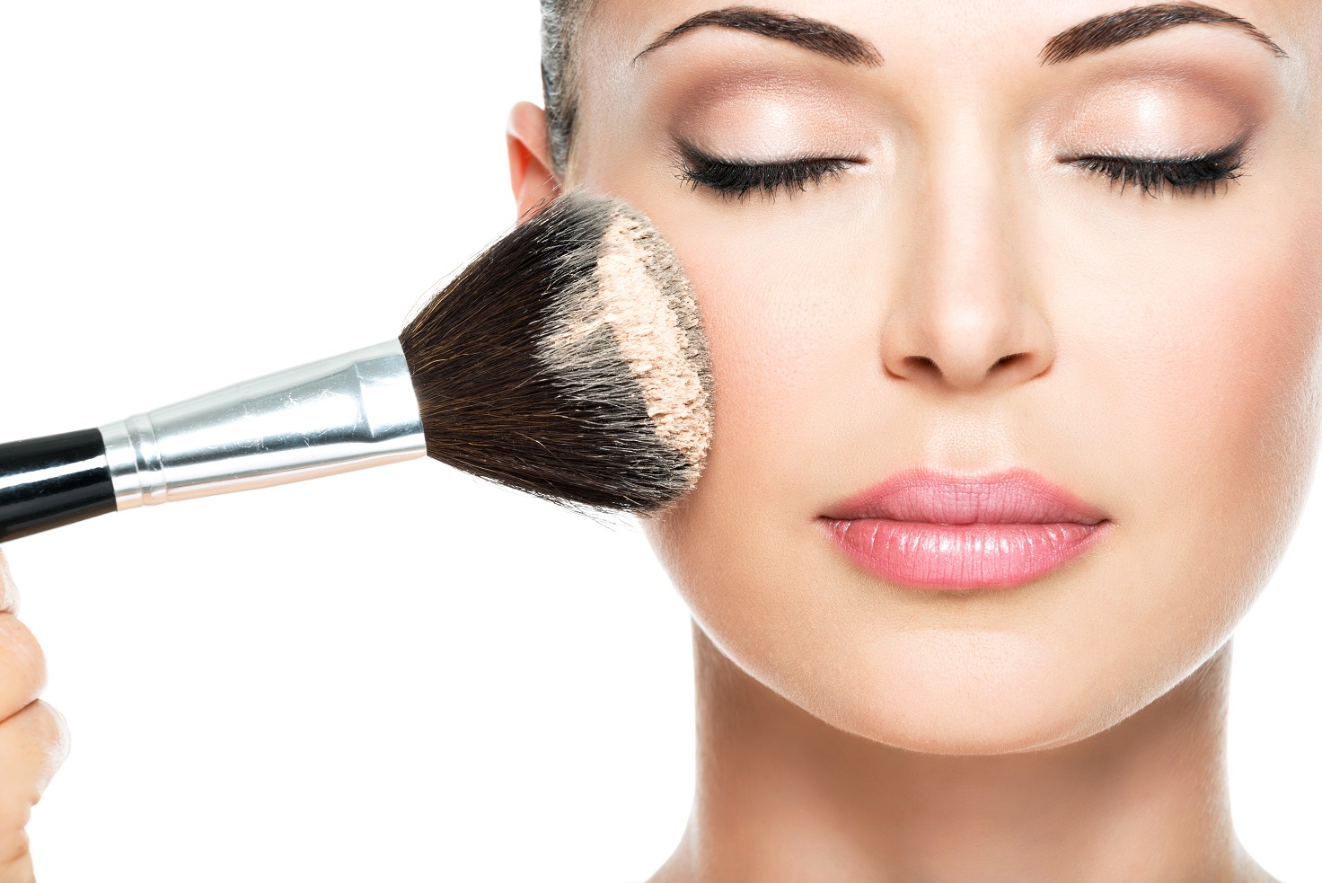 woman applying dry cosmetic tonal foundation on the face